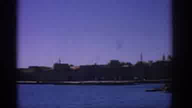RHODES GREECE-1962: Coastal View of Castle and Harbor from Boat