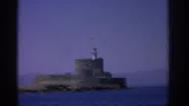 Rhodes Greece (1962): View Of Grey Stone Structure And Blue Sea Water On A Clear