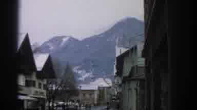 Munich Germany (1963): Snow Mountains Town Roofs White People Zoom Sign Trees Top