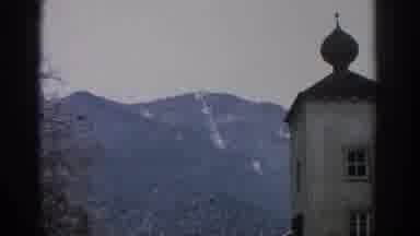 Munich Germany (1963): View Of White Object On Tree Covered Mountain On A Clear