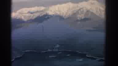 Munich Germany (1963): Gritty Birds Eye View Flying Over Snow Covered Mountains