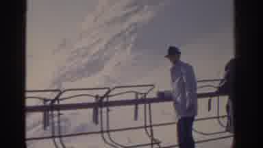 Munich Germany (1963): Man Wearing White Coat Looks At New Powder Snow From Ski
