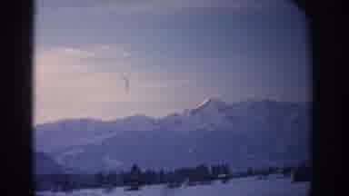 Munich Germany (1963): Driving Through A Town Showing The Mountains