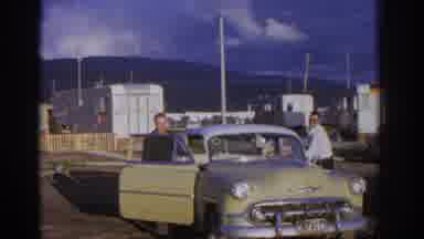 Zurich Swizterland (1963): Two Men Get Into Yellow Car On A Sunny Day