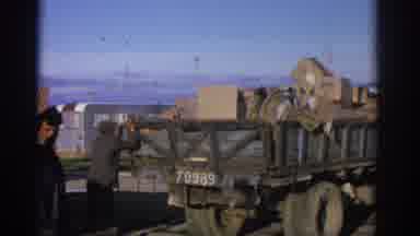 ZURICH SWIZTERLAND-1963: Men Loading Boxes Onto Flatbed Truck