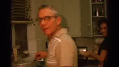 ZURICH SWIZTERLAND-1963: Man and Woman Cooking in Mid-Century Kitchen
