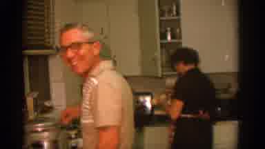 ZURICH SWIZTERLAND-1963: Family Cooking And Dining Together In Vintage Kitchen