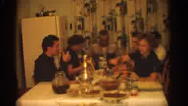 ZURICH SWIZTERLAND-1963: Men And Women Gathered Around Dinner Table Sharing A Meal