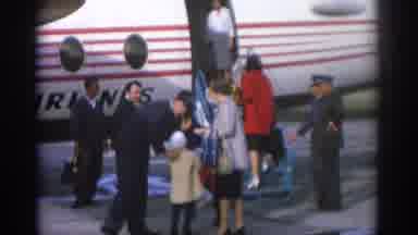 ZURICH SWIZTERLAND-1963: Passengers Boarding Airliner with Red and White Stripes
