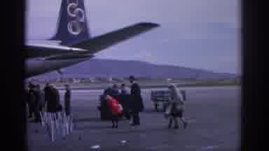 ZURICH SWIZTERLAND-1963: Passengers Boarding Commercial Airplane With Luggage