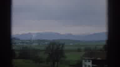 ZURICH SWIZTERLAND-1963: Rolling Mountains In Green Grass With White Tops Near