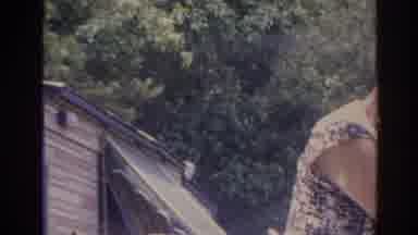 Florida USA (1962): Two Aged Women Working On The Rooftops While A Girl Throws A