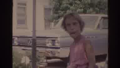 Florida USA (1962): Girl Making A Funny Face In Front Of An Older Lady Cooking