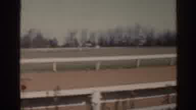 Florida USA (1962): Person Drives Green Tractor Down Empty Horse track On A Sunny