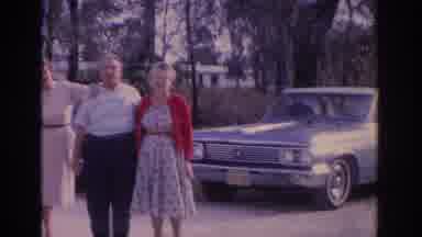 Florida USA (1962): Elderly Couple Stands Next To Blue Car On A Sunny Day