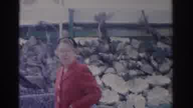 Florida USA (1962): A Woman In Red Is Standing In Front Of A Building Next To A
