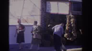 FLORIDA USA-1962: People Walk Down A Sidewalk In Front Of A Sponge Shop While A Man Sweeps