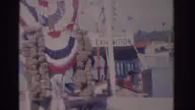 Florida USA (1962): Bunting Flaps In The Wind Next To A Docked Ferry Followed By A