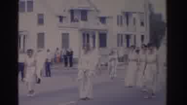 Florida USA (1962): Women Wearing White Dresses Walking In Street On A Clear Day