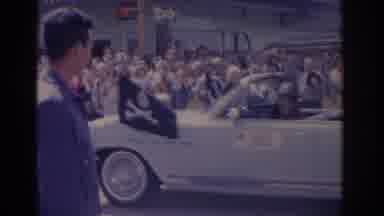 Florida USA (1962): People Watching A Parade A White Car Passes By While Some