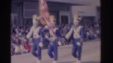 Florida USA (1962): Flag Bearers Wearing Blue Uniforms Precede Marching Band In