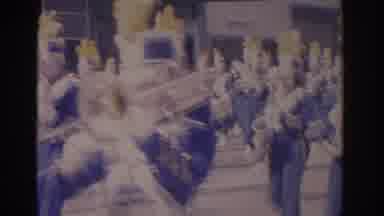 Florida USA (1962): Band In Blue And White Uniforms Marches Down A Street