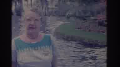 Florida USA (1962): Old Lady At The Garden With Pink Flowers And Water Flowing On