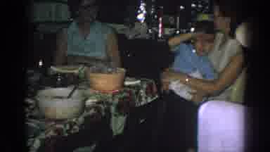 Gary Indiana (1962): Woman Wearing White Shirt Holds Small Boy Wearing Blue Shirt