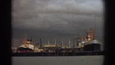 Izmir Turkey (1962): A Pair Of Black And Orange Ships Docked At Port On A Sunny
