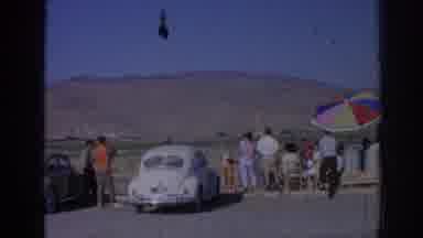 Izmir Turkey-1962: Vintage Gathering Near Classic Beetle In Arid Landscape