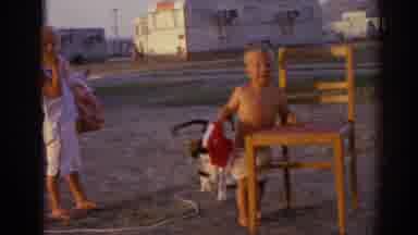 Izmir Turkey (1962): Pet Dog In Yard Trying To Take Toy Truck From Toddler While