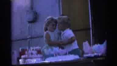 Izmir Turkey (1962): Boy Wearing White Shirt Kisses Girl Wearing Green Dress On