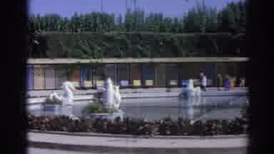 Izmir Turkey (1962): Child Running Up To Adult At Swan Fountain On Crowded Day