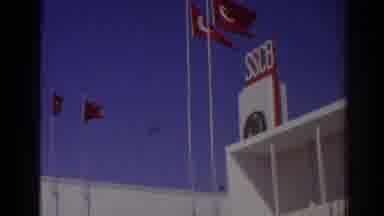 Izmir Turkey (1962): View Of Red And Yellow Turkish Flags Against Blue Sky On A