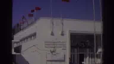 Izmir Turkey (1962): View Of White Building With Nine Flagpoles On A Sunny Day