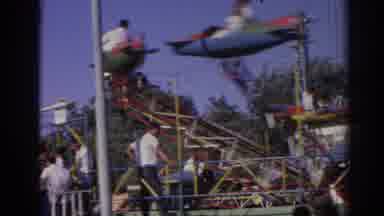 Izmir Turkey (1962): People Riding In Airplane Amusement Park Ride On A Sunny Day