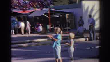Izmir Turkey (1962): Girl Wearing Blue Shirt Holds Balloons On A Sunny Day