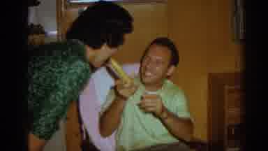 Izmir Turkey (1962): Woman Wearing White Shirt Serves Beverages To Guests Sitting