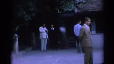 Izmir Turkey (1962): Man In Suit And Woman In Black Are Passed By Two Young Men