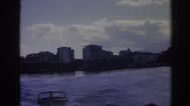 Izmir Turkey (1962): A Boat Riding Together With Another Boat Close A Town