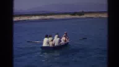 Izmir Turkey (1962): A Group Of People Row A Boat Out Into The Blue Lake Together