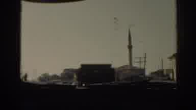 Izmir Turkey (1962): Car Filming Truck Moving City Near Tower In A City