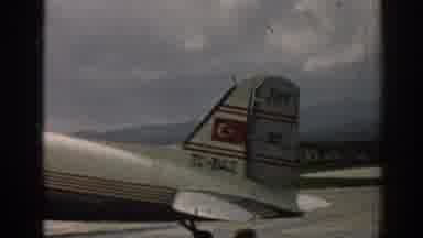 Izmir Turkey (1962): Vintage Airplane Arrives At Terminal While Onlookers Wait For