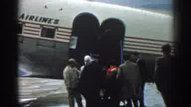 Izmir Turkey (1962): Old Footage Of Man And Woman Boarding A Plane On A Grey Day