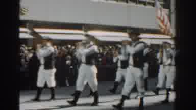 New York City (1962): Band Marching And A Lady In Yellow Walking With A Baton At A