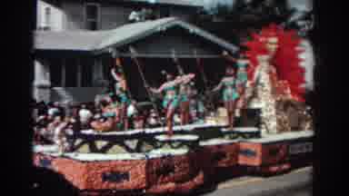 Pasadena California (1962): Women Wearing Blue Swimwear Wave From Red Parade Float