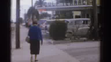 Florida USA (1963): An Old Film Showing A Lady Walking Down The Avenue With A Bag