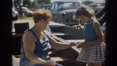 New Jersey USA (1963): Woman Hand Something To The Other Woman Who Hands The