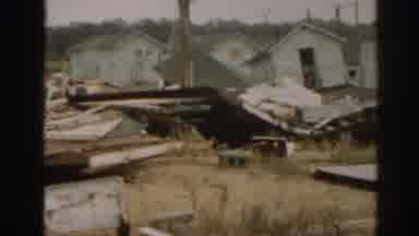 New Jersey USA (1963): View Of Damaged To Small White Structures On A Clear Day