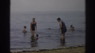 New Jersey USA (1963): Family Playing In The Water At The Beach with Their Dog